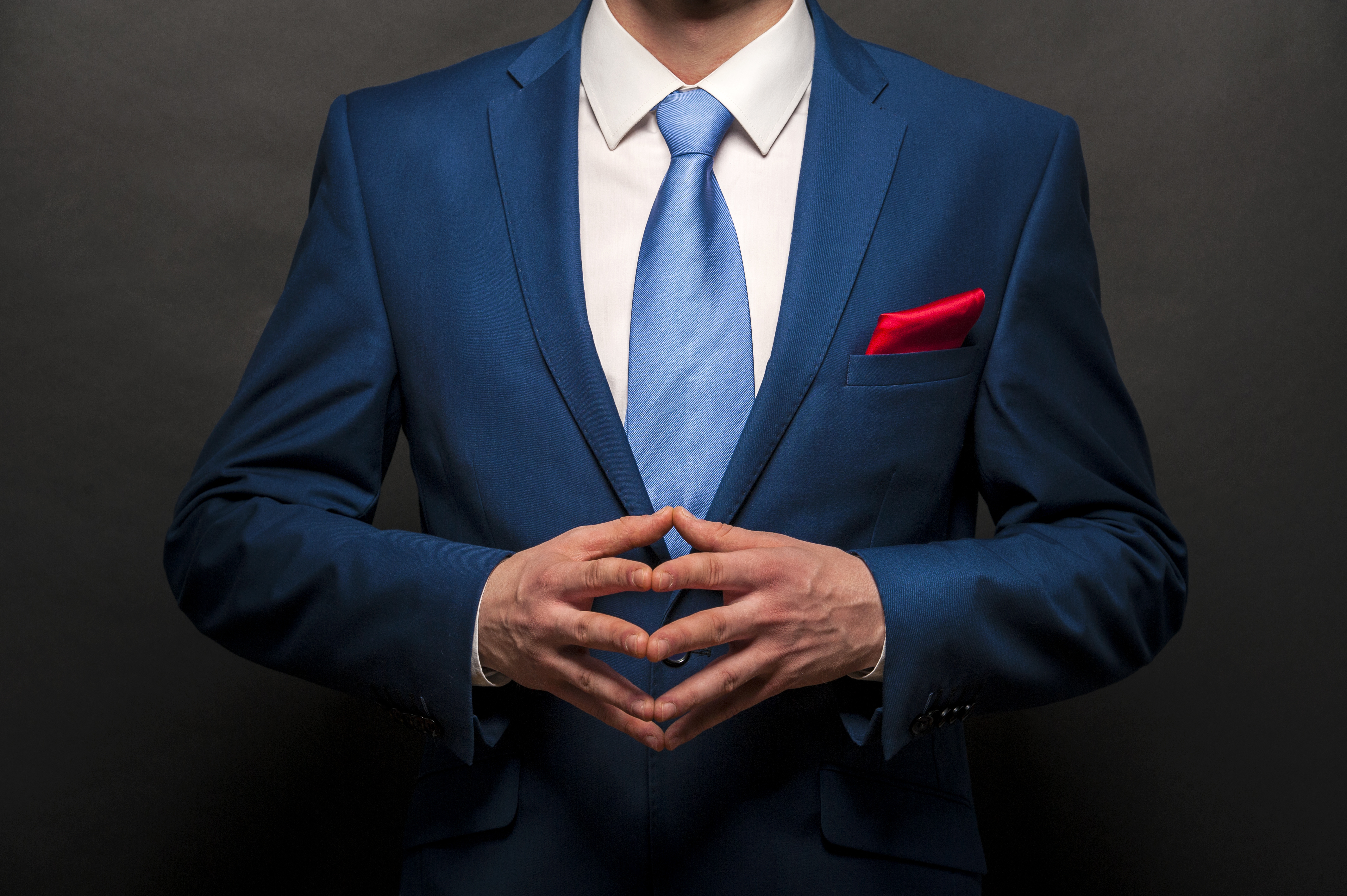 Tailored navy suit with blue tie and red pocket square